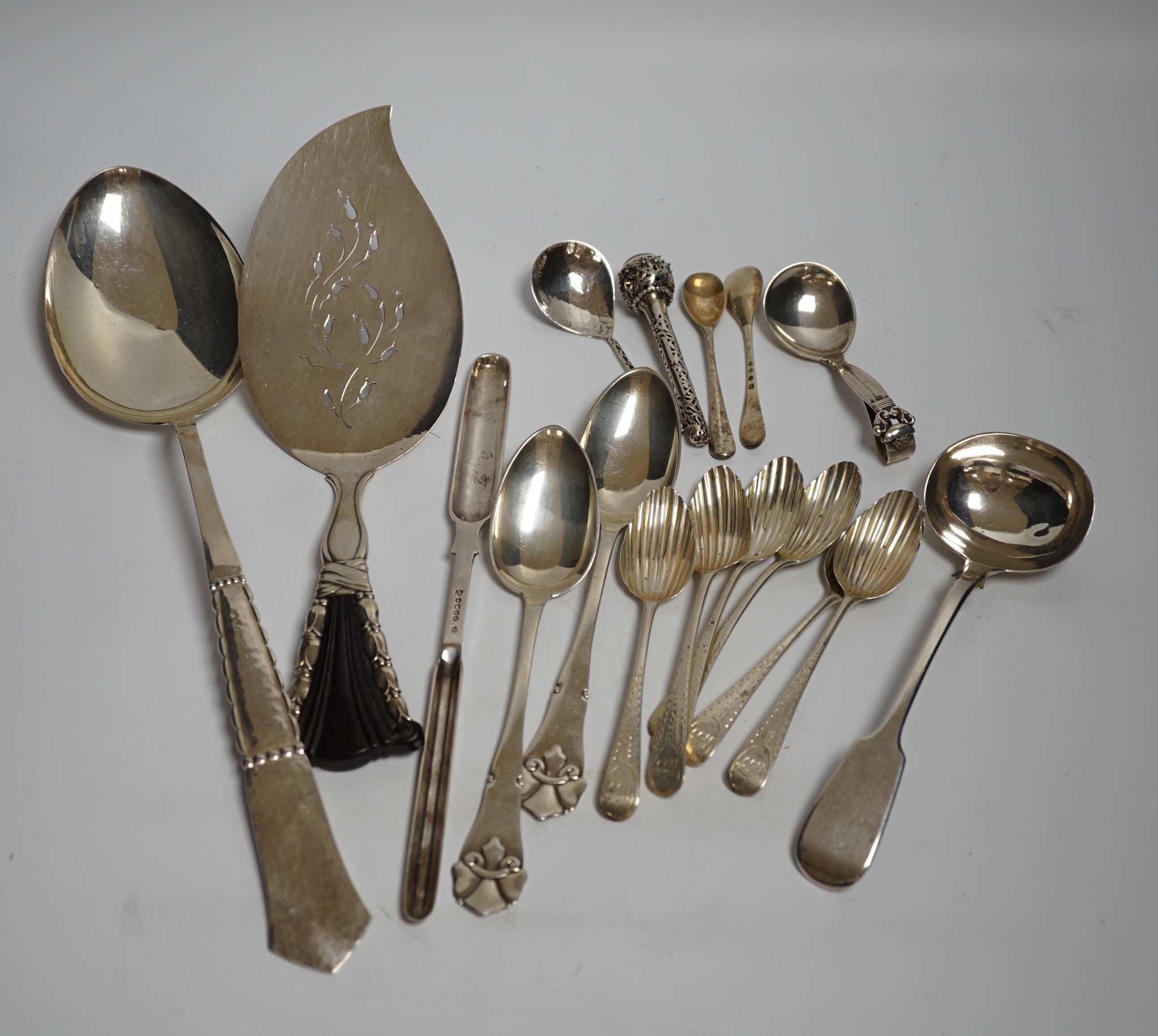 An early to mid 20th century Georg Jensen sterling and hardwood server, 26.1cm and a similar caddy spoon, together with other silver flatware, Scandinavian flatware and a plated marrow scoop.